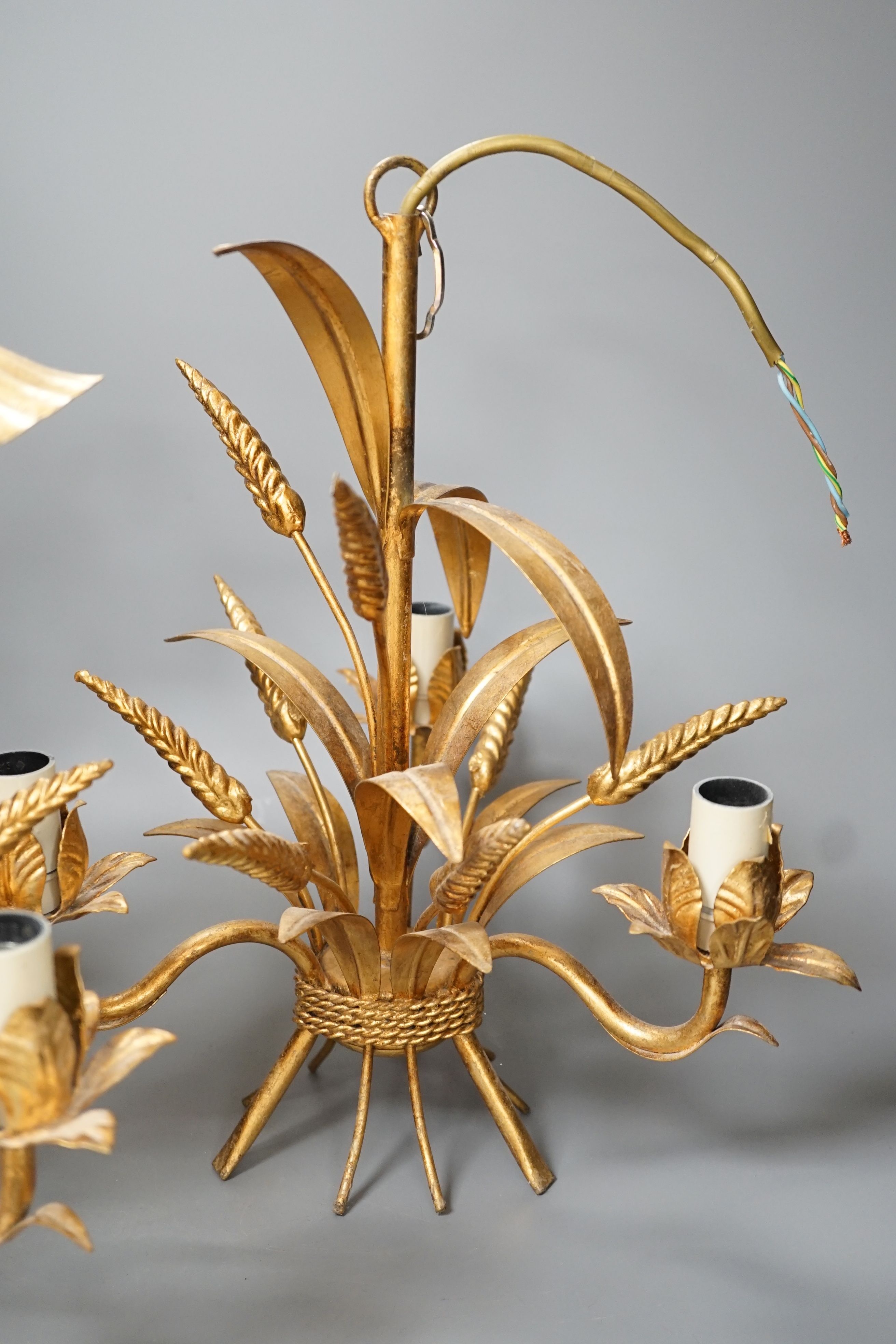 A pair of gilt metal wheat sheaf three light chandeliers